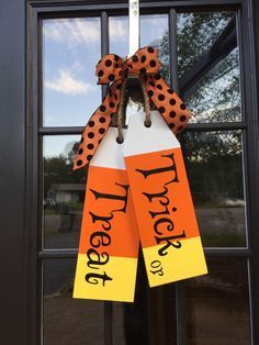 a door hanger decorated with orange and black polka dots