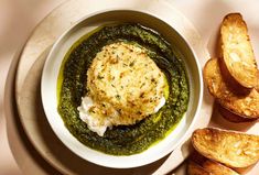 a white bowl filled with pesto and bread