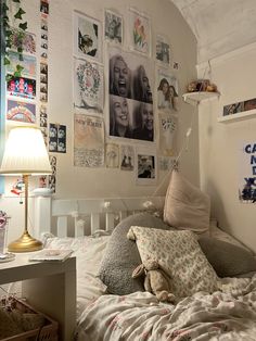 a bedroom with many pictures on the wall