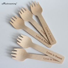 five wooden spoons with love is sweet written on the side and forks attached to them