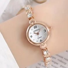 Rhinestone & Heart Quartz Bracelet Watch Round Dial Wristwatch Very Pretty Watch For Any Occasion Or Gift For Your Loved Ones. Dial: Round White Watch Diameter: 0.87 In Band Width: 0.24 In Band Length: 7.8 In Weight: 28g Stock Id: Tjb47-Wa04 Elegant Formal Alloy Watches, Rose Gold Watch With Rhinestones As Gift, Rose Gold Watches With Rhinestones For Gifts, Rose Gold Rhinestone Watch As Gift, Elegant Silver Watch For Valentine's Day, Elegant Gold Watch For Valentine's Day, Valentine's Day Elegant Silver Watch, Round Crystal Watch As Gift, Silver Alloy Watch For Gift