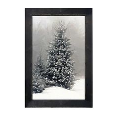 a black and white photo of a snowy christmas tree