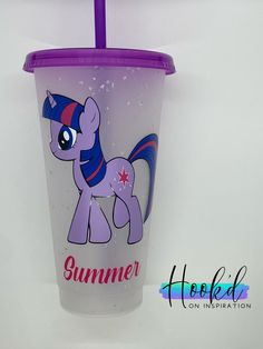 a plastic cup with a purple lid has a pony on it and the words summer is written in pink