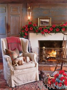 a living room filled with furniture and a fire place in front of a christmas tree