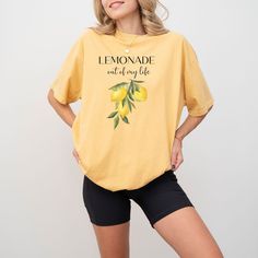 Make Life a Lemonade Stand: Positive Vibes Tee (100% Cotton) Turn life's sour moments into something sweet with this uplifting 100% cotton tee.  Featuring the refreshing message "Lemonade Out of My Life" and playful lemon graphics, this shirt is a reminder to find the sunshine even when faced with challenges. Made with breathable cotton, this tee is perfect for spreading positivity wherever you go. It's a great conversation starter and a way to inspire others to find the good in life. Here's why Casual Cotton T-shirt With Lemon Print, Yellow Summer T-shirt For Loungewear, Yellow T-shirt For Summer Loungewear, Yellow T-shirt With Lemon Print For Spring, Yellow Spring T-shirt For Loungewear, Yellow T-shirt For Loungewear In Spring, Spring Cotton T-shirt With Lemon Print, Yellow T-shirt For Spring Loungewear, Spring Lemon Print Cotton Top