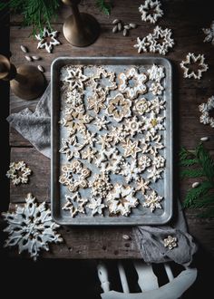 a cookie sheet covered in white frosting and sprinkled with snowflakes