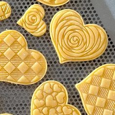 some heart shaped cookies sitting on top of a cookie sheet