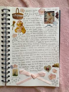 an open notebook with many pictures and writing on it, along with a pink ribbon