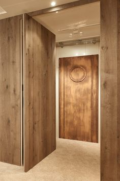 an empty room with wooden doors and carpet