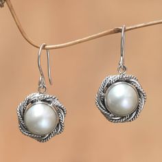 The white roses that blossom throughout Bandung the City of Flowers inspires Rosalia Tarigan in the design of these earrings. Centered by silvery-white mabe pearls the florid earrings are crafted by hand with sterling silver. .925 Sterling silver