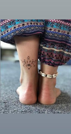 a woman's foot with a small tattoo on her left ankle and the bottom part of her leg