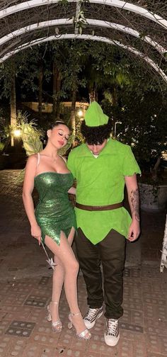 a man and woman dressed up as tinkerbells