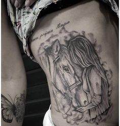 a woman's stomach with a horse and butterfly tattoo on it