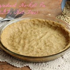 a glass jar filled with food sitting on top of a lace covered table cloth next to a wooden spoon