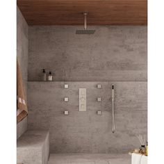 a modern bathroom with concrete walls and flooring, including the shower head and handset