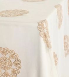 a white table cloth with gold designs on it