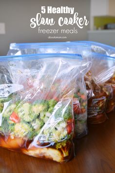 five bags of food sitting on top of a wooden table