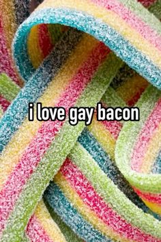 the words i love gay bacon are written in multicolored candy canes on top of each other