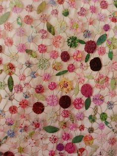 an old quilt with flowers and leaves on it