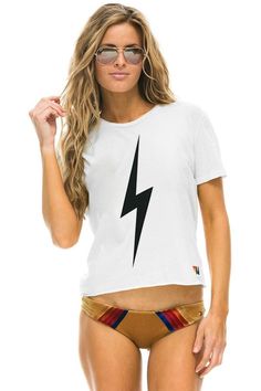 WOMEN'S BOLT BOYFRIEND TEE - WHITE - Aviator Nation White Edgy Crew Neck T-shirt, Edgy White Tops With Logo Print, Edgy White Short Sleeve T-shirt, Edgy White T-shirt With Logo Print, Ninja Hoodie, Moto Pants, Aviator Nation, Striped Jacket, Striped Hoodie