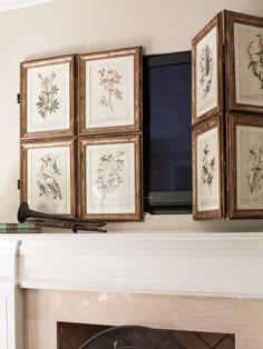 a fireplace with four framed pictures on the mantle