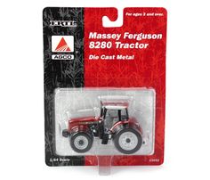 a red and black toy tractor with white wheels on it's back pack in a package