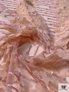 Beds of pink flowers in perfect rows are pretty as can be on this blush and pink fine netting with 3D floral chiffon appliqués and sequins detailing designer fashion fabric. SKU: 12322 Content: Polyester Color: Blush / Pink Width: 50 inches This fabric is a last cut and no longer in production. Once sold out, we are unable to get more. Elegant Pink Sequin Fabric With Floral Embroidery, Spring Pink Tulle Fabric, Pink Tulle Fabric For Summer Parties, Elegant Pink Tulle Fabric For Spring, Pink Organza Tulle Fabric For Spring, Pink Tulle Fabric With Appliques For Party, Pink Party Tulle Fabric With Appliques, Pink Tulle Fabric For Summer Wedding, Embellished Tulle Fabric For Spring Wedding