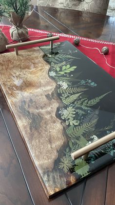 a wooden table topped with a painting on top of it