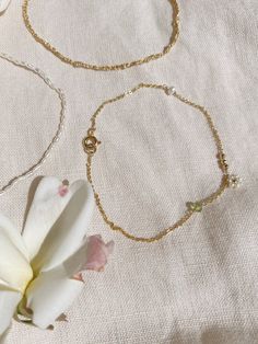 + DAISY CHAIN FRIENDSHIP BRACELET +Tiny Natural Pearls surround a 14ky Gold-filled bead to make this daisy chain bracelet along with a three 2mm 14ky gold-filled beads, a pearl, and Peridot rondelle or you can keep it simple with just one daisy beads in center. Its a melody of stones and pearls along your wrist. A perfect and sweet bracelet that is an upscale friendship bracelet. The pearls are Natural fresh water pearls that should not be exposed to water or liquids. Tiny Ball beads and chain a Dainty 14k Gold Bracelet With Pearl Chain, Delicate Hypoallergenic Jewelry For Friendship, Delicate Beaded Bracelet With Adjustable Chain For Gift, Delicate Beaded Bracelets With Adjustable Chain, Delicate Gold Bracelet With Chain As Gift, Delicate Yellow Gold Beaded Bracelets As Gift, Dainty Beaded Bracelets With Adjustable Chain, Delicate Yellow Gold Beaded Bracelet For Gift, Delicate Yellow Gold Beaded Bracelet As Gift