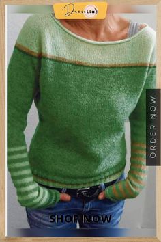 the woman is wearing a green sweater and jeans with her hands in her pockets,