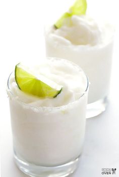 two glasses filled with ice cream and lime slices