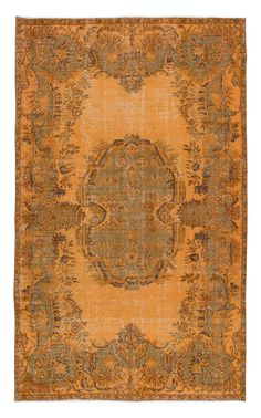 an orange and green rug with ornate designs