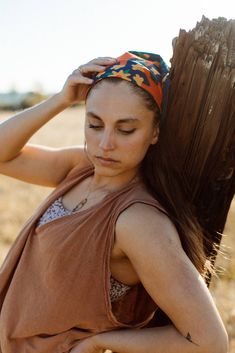 a woman with her hair tied back and wearing a bandana