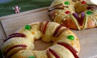 two bundt cakes sitting on top of a counter next to each other, decorated with candy