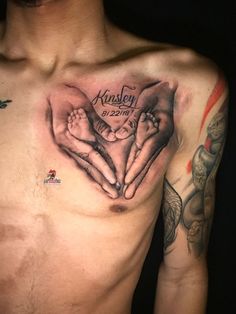 a man's chest with two hands in the shape of a heart on it