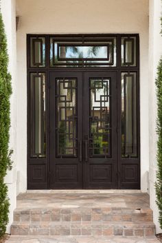 a black double door with glass panels and sidelights