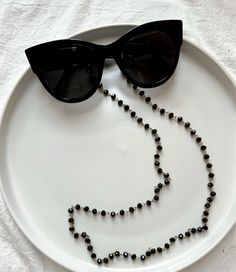 Sunglasses chain from a unique rosario with black beads and gold chain. You can put it in every pair of sunglasses that you wish. In Christina Christi Jewels store you can see a lot of fashion accessories for men and women. You can have them in 2-4 Days with DHL EXPRESS SHIPPING - Rosario Chain with black beads and gold chain that is made from metal. - You can choose in three different dimensions for your glasses. (70 - 80 - 90 cm) # FIND ALL MY DESIGNS IN GLASSES CHAINS HERE: https://etsy.me/2W Black Adjustable Glasses Chain For Parties, Black Glass Beaded Jewelry, Black Glass Glasses Chain For Parties, Adjustable Black Glasses Chains For Parties, Black Glass Chain Jewelry, Black Glass Round Bead Jewelry, Black Glass Round Beads Jewelry, Trendy Black Glass Jewelry, Elegant Black Glasses Chains For Party