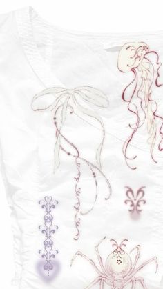 an embroidered piece of cloth with different designs on the front and back, including two jellyfishs