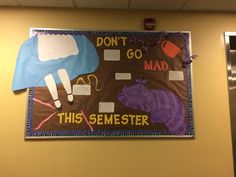 a bulletin board that says don't go mad, this semester is on the wall