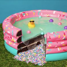 an inflatable pool with a cake inside and sprinkles on the ground