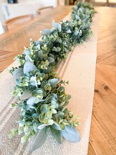 a long table with some green plants on it