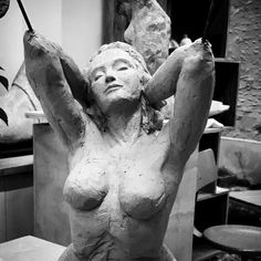 a statue is shown in black and white, with the woman's torso visible