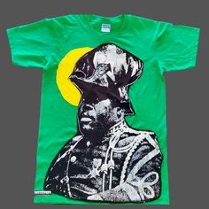 MARCUS GARVEY unisex t-shirt available in sizes S , M, L featuring high quality silk screen appliqué Fitted Streetwear T-shirt With Screen Print, Unisex Screen Print Shirt For Fan Merchandise, Unisex Fan Merchandise Shirt With Screen Print, Fitted Green T-shirt With Graphic Print, Fitted Green Graphic Print T-shirt, Streetwear Cotton Tops With Exclusive Print, Exclusive Print Short Sleeve T-shirt For Streetwear, Cotton Tops With Exclusive Print For Streetwear, Exclusive Print Cotton Tops For Streetwear