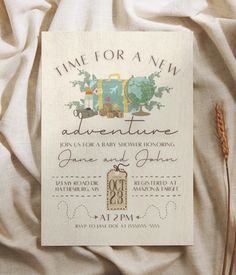 an adventure themed baby shower is displayed on a bed with white sheets and linens