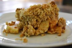 a close up of a plate of food with fruit and crumbs on it