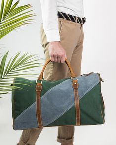 The FH Wadsworth Green Canvas & Blue Suede Duffel Bag is both stylish and functional. Made from a heavy duty green canvas and coupled with a diagonal light blue strip of suede. Brown full grain leather accents and side suede strips provide the perfect pop of color. This modern weekender bag brings luxury, durability, and timelessness to any destination. Conveniently meets all airline carry-on size requirements. Interior zipper pocket Detachable leather strap for shoulder or cross-body wear 2 Carry On Size, Leather Accents, Blue Suede, Weekender Bag, Duffel Bag, Full Grain Leather, Cross Body, Zipper Pocket, Messenger Bag