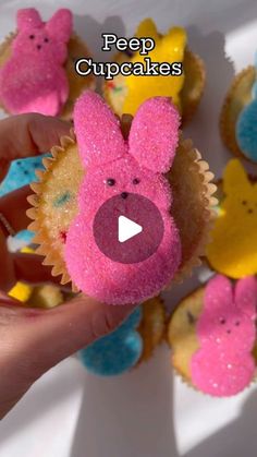 someone is holding up some cupcakes with pink frosting and peep ears on them