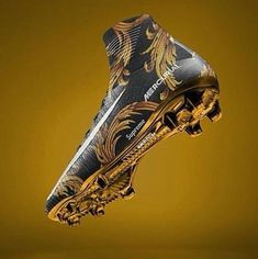 the nike football boot is decorated with gold and black designs on it's outstep