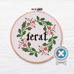 a cross stitch wreath with the word terd on it