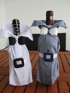 two wine bottles dressed up like sailors